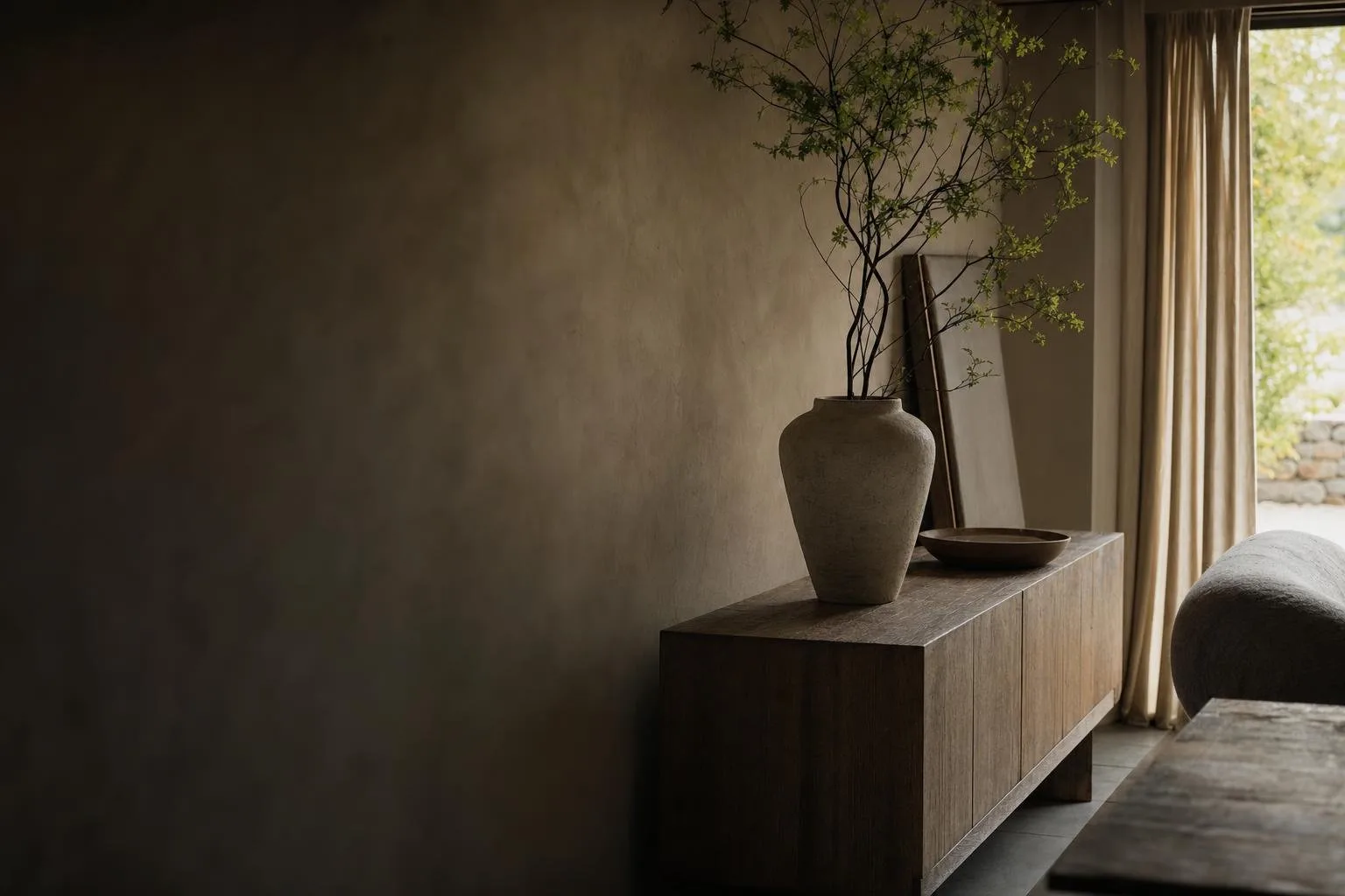 A sunlit living room with plaster walls and a linen sofa, styled like a gallery print