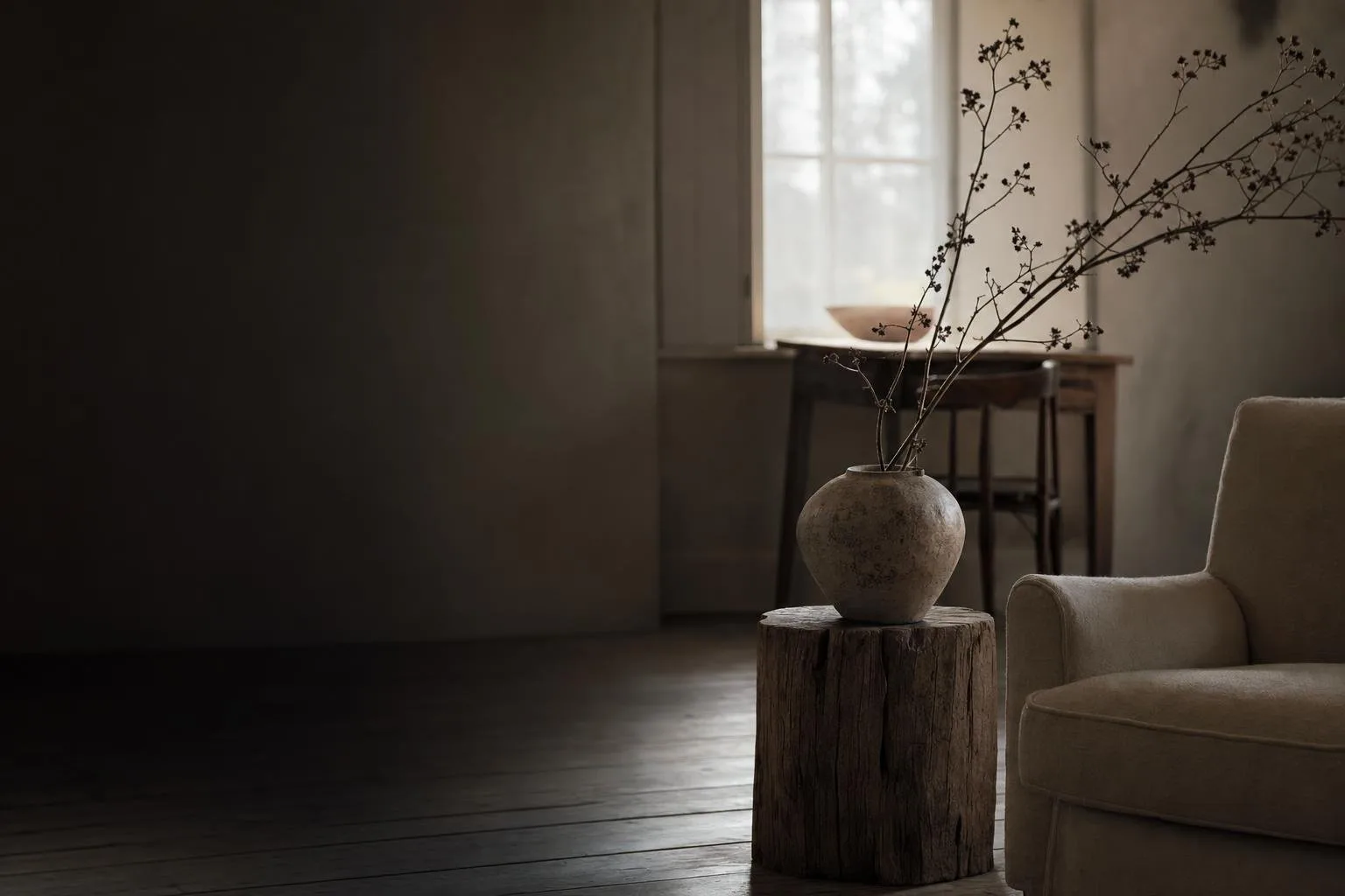 A quiet bedroom corner with framed prints catching soft morning light, gallery-white styling
